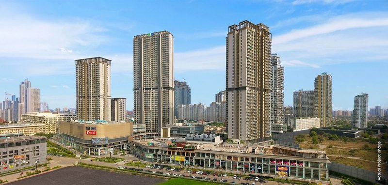 Residential towers rising over the retail podium at M3M 65th Avenue